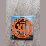 Balení kytarových strun D'Addario XL. Na obalu jsou nápisy NICKEL WOUND, REGULAR LIGHT GAUGE a kód EXL110. V horní části je uveden rozsah 10 | 46 a p…