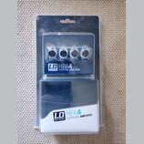 Modrý sluchátkový zesilovač v originálním plastovém balení. Na přístroji i na krabici je bílý nápis LD SYSTEMS HPA4 HEADPHONE AMPLIFIER. Zařízení má…