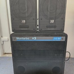 Sada tří černých reproduktorů, která obsahuje dva menší horní reproduktory a jeden velký spodní subwoofer. Na všech třech je viditelné logo s nápisem…