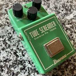 Zelený efekt pedál s kovovým šasi a třemi černými oválnými knoflíky. Na horní části je bílý nápis TUBE SCREAMER a pod ním menší text Overdrive Pro TS…