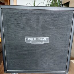 Černý kytarový reproduktor v kostce potažený vinylen s černou textilní maskou. Uprostřed je umístěn stříbrný oválný štítek s nápisem MESA ENGINEERING…