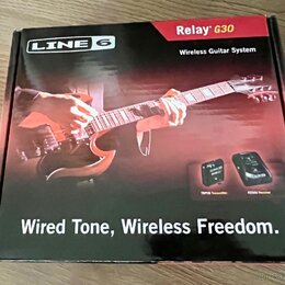 Kartonová krabice s nápisy LINE 6, Relay G30 a Wireless Guitar System. Na povrchu je fotografie rukou hrajících na červenou elektrickou kytaru a obrá…