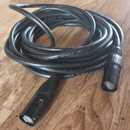 Černý svitkový kabel s konektory typu XLR na obou koncích. Na plášti kabelu je bílý nápis LAN CABLE a označení TIA/EIA. Povrch kabelu i konektorů vyk…