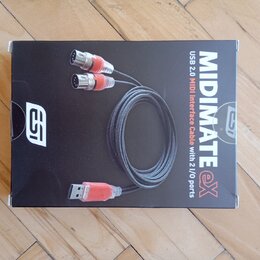 Fotografie znázorňuje černou krabici s produktem. Na obalu je zobrazen USB-MIDI kabel a nápisy MIDIMATE eX, USB 2.0 MIDI Interface Cable with 2 I/O p…