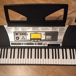 Černý digitální klavír s bílými a černými klávesami a přiloženým napájecím adaptérem. Na ovládacím panelu je nápis YAMAHA a model PSR-350, dále označ…