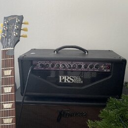 Černý kytarový kombozesilovač s nápisem PRS PAUL REED SMITH a označením SE 50. Na ovládacím panelu jsou knofíky a nápisy jako LEAD CHANNEL, CLEAN CHA…