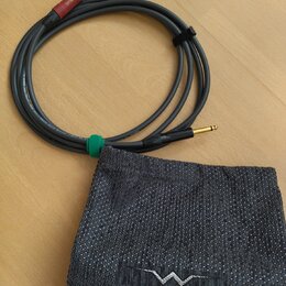 Šedý instrumentální kabel s pozlacenými konektory, sbalený do kruhu a zajištěný černým stahovacím páskem. Na červeném krytu konektoru je nápis silent…