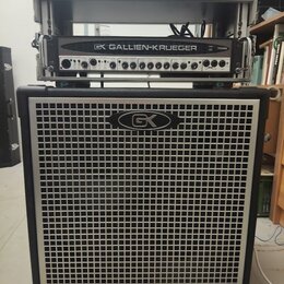 Basový kombozesilovač tvořený dvěma částmi. Horní racková jednotka nese nápis GK GALLIEN-KRUEGER 700RB. Spodní reproduktorová skříň má stříbrnou mříž…