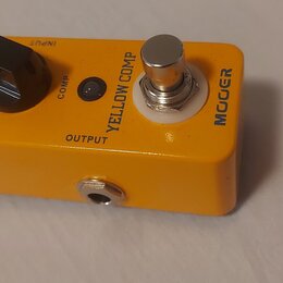 Žlutý efekt pedál s kovovým šasi. Na horní straně je nápis YELLOW COMP a logo MOOER, ovládací knoflík s popiskem VOLUME, menší knoflík COMP a stoupac…