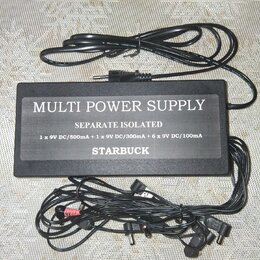 Černý napájecí adaptér s nápisem MULTI POWER SUPPLY, SEPARATE ISOLATED a STARBUCK. Pod názvem je uveden text 1 x 9V DC/500mA + 1 x 9V DC/300mA + 6 x…