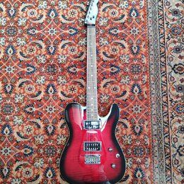 Elektrická kytara s červeným gradientem (sunburst) a viditelnou strukturou dřeva. Nástroj má dva humbuckery, jeden tónový potenciometr a jeden přepín…