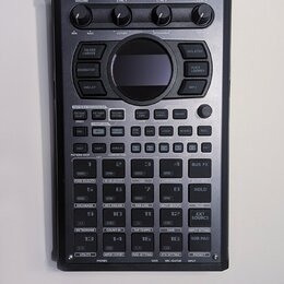 Černý sampler Roland SP-404MKII. Zařízení obsahuje několik otočných ovladačů, displej a mřížku 16 ovládacích padů. Povrch je v dobrém stavu bez vidit…