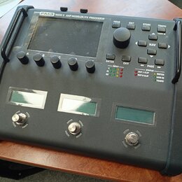 Černý kytarový procesor s nápisem FM3 MARK II AMP MODELER/FX PROCESSOR. Zařízení má velký displej, ovládací knoflíky a tlačítka s popisky HOME, EDIT,…