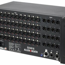 Černý rackový patchbay s velkým množstvím konektorů. Na zadním panelu je nápis GX4816 a logo ALLEN&HEATH. Horní část panelu je rozdělena na sekce Inp…