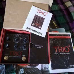 V kartonové krabici se nachází černý efekt pedál s nápisy TRIO+ a Band Creator + Looper. K zařízení patří Quick Start Guide, Owner's Manual s nápisem…