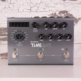 Šedý kytarový efekt s kovovým povrchem a nápisem strymon TIMELINE. Zařízení má čtyři hlavní otočné ovladače označené TIME, REPEATS a MIX, dále tři me…