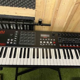 Černý MIDI kontrolér s klaviaturní klávesnicí. Na levé straně je červené logo AKAI PROFESSIONAL a bílý nápis MPK261. Horní panel obsahuje mřížku padů…