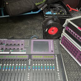 Digitální mixovací pult s nápisem ALLEN&HEATH GLD-80, vybavený faderem, tlačítky a displejem. Vedle pultu jsou dva rackové stageboxy s fialovými pane…