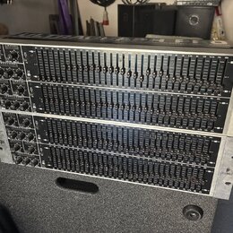 Dvě stříbrné rackové jednotky s grafickými ekvalizéry. Na obou zařízeních je v horní části nápis ULTRAGRAPH GEQ a v levé části označení FBQ. Na pravé…