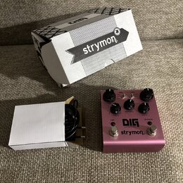 Růžový efekt pedál s nápisy DIG dual digital delay a strymon. Na horní straně jsou čtyři černé ovládací knoflíky, dva spínače s nápisy TAP a BYPASS a…