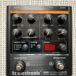 Černý kytarový efekt s nápisem tc electronic a modelem NDR-1 NOVA DRIVE ANALOG OVERDRIVE + DISTORTION. Zařízení má osm otočných knoflíků s popisky ov…