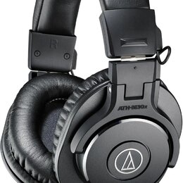 Černá uzavřená sluchátka s polstrovaným náhrobkem a mušlemi z koženky. Na vnější straně mušle je nápis ATH-M30x a logo Audio-Technica. Na náhrobku je…