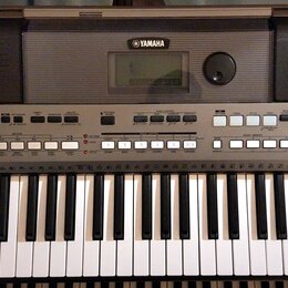Šedý elektronický klavír s bílými a černými klávesami. Na horní části je uprostřed logo YAMAHA, displej a po obou stranách mřížkovité reproduktory. V…