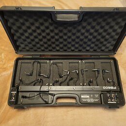 Otevřený černý přepravní kufr s vnitřním akustickým tlumivem ve víku. Uvnitř se nachází černý pedalboard s nápisem PB600 a textem LOUDSOUND EFFECTS P…