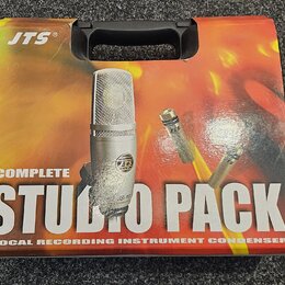 Kartonová krabice s černou plastovou rukojetí. Na povrchu je nápis JTS® a velký text COMPLETE STUDIO PACK, pod kterým je uveden popis VOCAL RECORDING…