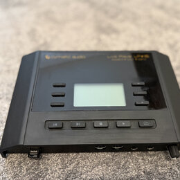 Černý elektronický přístroj s displejem uprostřed a ovládacími tlačítky. V horní části je zlatý nápis Cymaitic audio a Live Play LP 16. V dolní části…