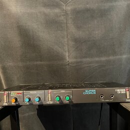 Černý rackový efektový procesor s nápisy BOSS CE-300 a SUPER CHORUS. Přední panel obsahuje vstupní a výstupní konektory, několik ovládacích knoflíků…