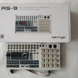 Na fotografii je bílý modul Rhythm Sequencer RS-9 od značky behringer, umístěný před svým původním kartónovým obalem. Modul má bílé provedení s černý…