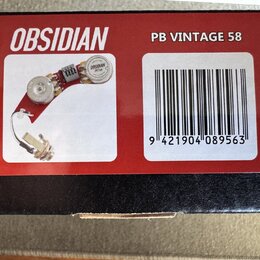 Fotografie krabičky s červeným a černým potiskem. Na povrchu je bílý nápis OBSIDIAN a PB VINTAGE 58, dále čárcový kód s číslem 9 421904 089563. Vlevo…