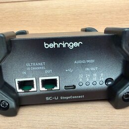 Černý elektronický modul značky behringer s označením SC-U StageConnect. Zařízení obsahuje dva ethernetové porty označené jako ULTRANET 16 CHANNEL IN…