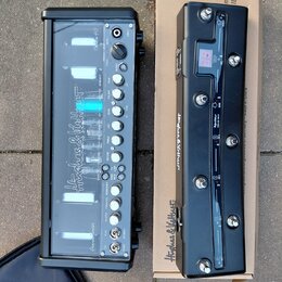 Dvě černé elektronické zařízení značky Hughes & Kettner. Levý přístroj má ovládací panel s několika otočnými knoflíky a přepínači, v horní části je r…