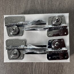 Dvě sady chromovaných ladících mechanismů v bílém kartónovém obalu. Každý mechanismus má na kovové základně vyražený nápis Fender. Součástí jsou ladi…