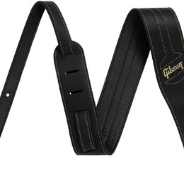 Černý kožený popruh na hudební nástroj s bílým prošíváním po okrajích. Na pravém konci je zlatým nápisem vyrazeno logo Gibson. Popruh má v jedné část…