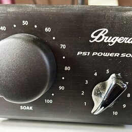 Černý přístroj s nápisy Bugera a PS1 POWER SOAK. Na přední straně jsou dva ovládací knofíky; větší s označením SOAK a stupnicí od 20 do 100, menší s…