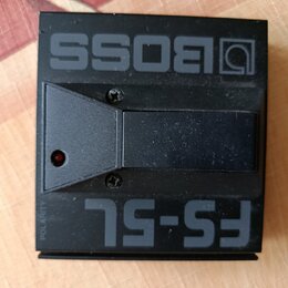 Černý nožní spínač z plastu s nápisy BOSS a FS-5L. Na levé straně je umístěna malá červená kontrolka a svislý nápis POLARITY. Povrch je matný s vidit…