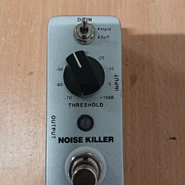 Stříbrný kytarový pedál s nápisy NOISE KILLER a MOOER. Obsahuje jeden černý otočný knoflík s označením THRESHOLD a hodnotami od -70 do +10dB, přepína…