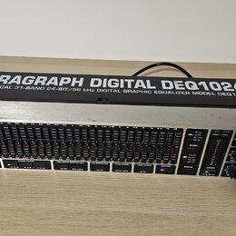 Digitální grafický ekvalizér v rackovém provedení s kovovým šasi. Na horní části je nápis ULTRAGRAPH DIGITAL DEQ1024 a pod ním text ULTRA-MUSICAL 31-…