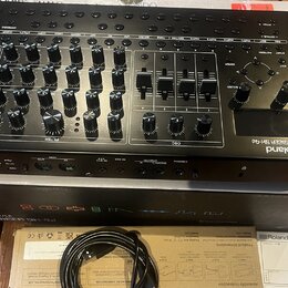 Černý syntetizátor Roland SYNTHESIZER SH-4d s velkým množstvím otočných knoflíků, posuvníků a ovládacích prvků. Na přední straně je viditelné logo Ro…