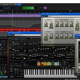 Snímek zachicuje obrazovku počítače s otevřeným softwarem Mixcraft 9 Pro Studio. V programu jsou vidět různé zvukové stopy, mixážní konzole a otevřen…