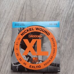 Balení kytarových strun D'Addario XL. Na obalu jsou nápisy NICKEL WOUND, REGULAR LIGHT GAUGE a kód EXL110. V horní části je uveden rozsah 10 | 46 a p…