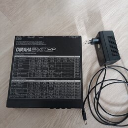 Černý efektový procesor YAMAHA EMP100 MULTI-EFFECT PROCESSOR s bílým tabulkovým přehledem parametrů na horní straně. Zařízení má v zadní části konekt…