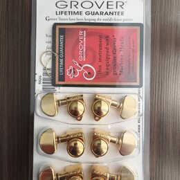 Zlaté ladicí mechanismy značky GROVER v originálním plastovém balení. Na horní části obalu je nápis GROVER LIFETIME GUARANTEE a červený štítek s text…