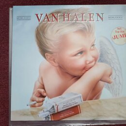 Fotografie zobrazuje obal CD s albem skupiny VAN HALEN. Na přední straně je zobrazen malý křídlatý chlapec s cigaretou v ruce a krabičkou cigaret pře…