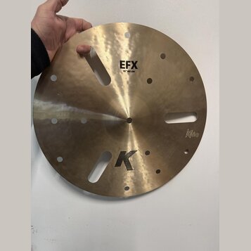 Zlatavý kovový činel s několika otvory různých tvarů a velikostí. Na povrchu jsou čitelné nápisy EFX, 16"/40 cm a logo K. V pravé dolní části je malý…
