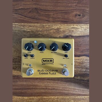 Žlutý efekt pedál s nápisy MXR, sub octave bassfuzz a BASS INNOVATIONS. Zařízení má tři černé otočné ovladače s popisky GAIN, FUZZ a DRY, tři přepína…