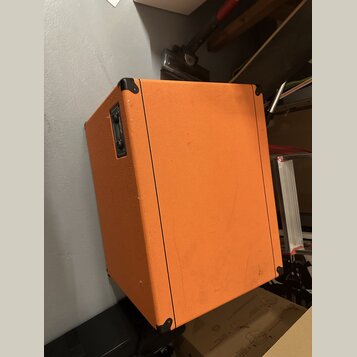 Kytarový kombozesilovač potažený oranžovým texturovaným vinylem s černými plastovými rohy. Na boční straně je umístěn černý ovládací panel s přepínač…
